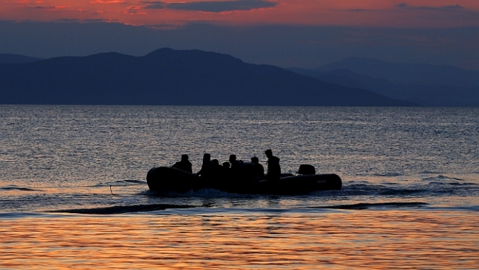 A dinghy with Syrian refugees is towed by a Greek coast guard patrol boat into port on Greek island of Kos, following a rescue operation, May 31, 2015