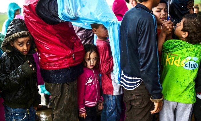 Child refugees queuing for food at the makeshift camp at Idomeni, northern Greece