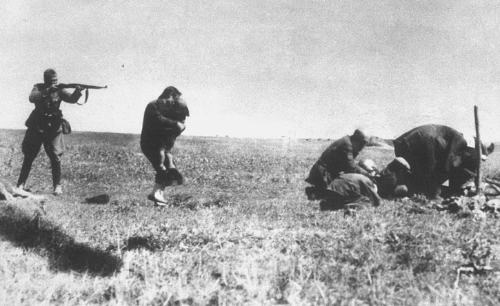 A Nazi soldier murdering Jewish civilians, including a mother and child, in 1942, at Ivanhorod, Ukraine.
